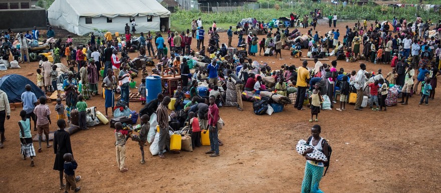 Refugees from South Sudan wait at a UNHCR collection point in Elegu, Uganda. © UNHCR/Will Swanson