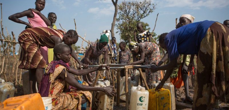 Women work to collect water in the Nguneyyiel refugee camp in the Gambella region of Ethiopia on 26 Nov 2017. Photo by: Zacharias Abubeker