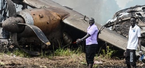 People stand near the cargo plane that crashed in Juba shortly after takeoff [David Dhal Malual/AFP]