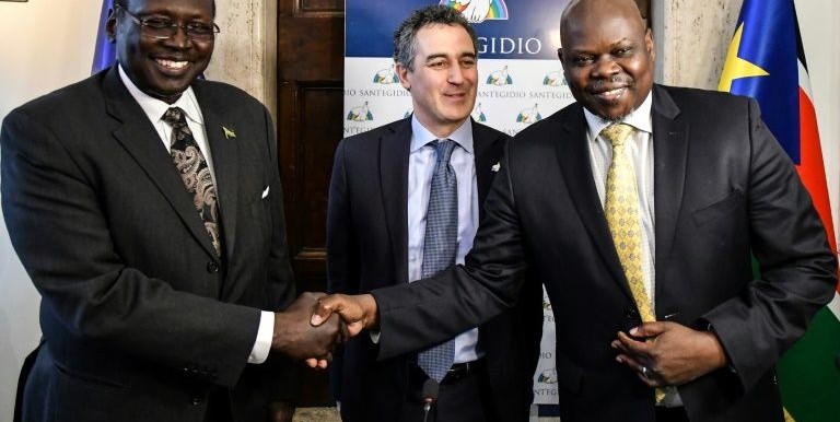 South Sudan's Presidential Advisor, Dr. Barnaba Marial Benjamin [Left] shakes hand with SSOMA's Pagan Amum as Paolo Impagliazzo, Sant’Egidio secretary-general looks on in December 2020. Courtesy