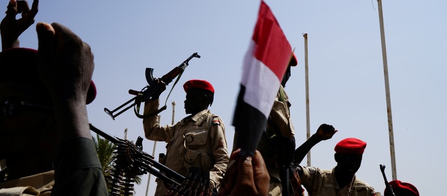 Sudan's paramilitary Rapid Support Forces (RSF) soldiers greet people as they secure a site where Lieutenant General Mohamed Hamdan Dagalo, deputy head of the military council and head of RSF, attends a meeting in Khartoum in June [Photo: Umit Bektas/Reuters]