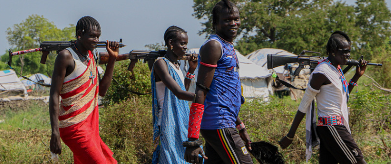Armed youth walk through Lekuangole town, GPPA. (Photo: TNH)