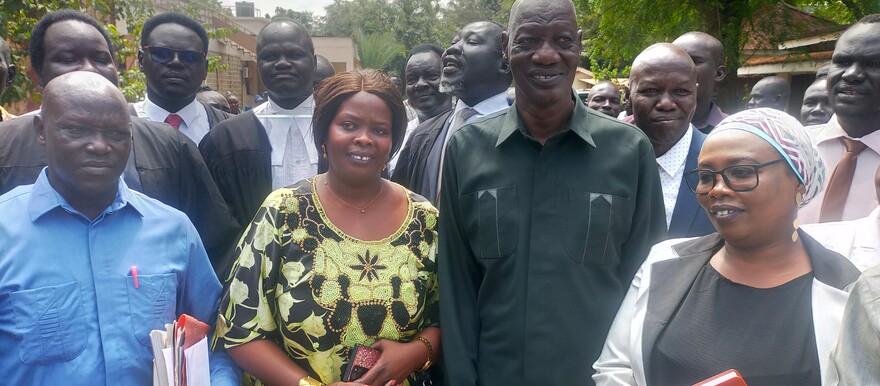 Ex-governor Kuel Aguer Kuel poses with family and his lawyers after the High Court exonerated him of treason charges in Juba on 09 December 2022. [Photo: Radio Tamazuj]