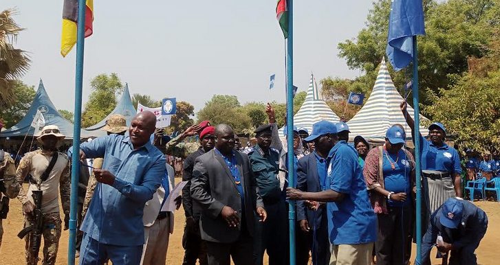 (L-R) Governor Lobong, Oyet Nathaniel, and Lodira hoist the Eastern Equatoria, National, and SPLM-IO flags respectively. (Photo: Radio Tamazuj)