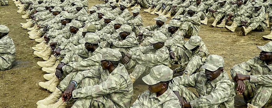 Soldiers belonging to the Unified Forces sit on the ground during a deployment ceremony at the Luri Military Training Centre in Juba on November 15, 2023. (PETER LOUIS GUME/AFP)