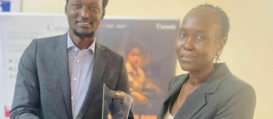 Governor Denay Jock Chagor gives then Minister Atong Kuol an award for best-performing minister in Jonglei State in February. (Courtesy photo)