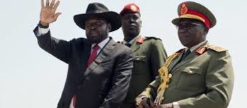 Photo: President Kiir, left, accompanied by army chief of staff Paul Malong, right, waves during an independence day ceremony in Juba (Credit: VOA)