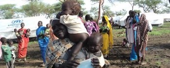 Photo: A woman and child at a medical transit site in Jamam Camp near the MSF-Holland clinic, June 2012. (Radio Tamazuj)