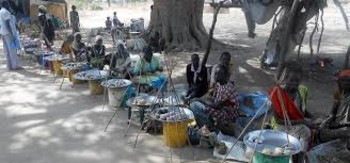 File photo: Women sit with food that they hope to sell in Manyiel village/NRC
