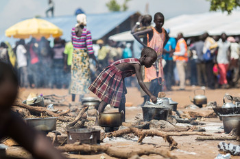 A young South Sudanese refugee cooks food at a camp in northern Uganda Photo: UNHCR/Will Swanson