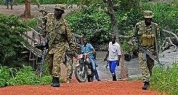 Ugandan army officials patrol near the Kaya River at the South Sudanese border point on July 30, 2017/UNHCR