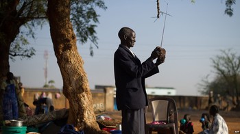 Photo: A displaced South Sudanese man tunes his radio  (BBC)