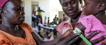 File photo: A health worker screens a South Sudanese child for signs of malnutrition at a health center in Nyumanzi refugee settlement in Uganda, May 2017. © UNHCR/Jiro Ose.