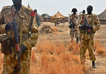 Sudan People's Liberation Army (SPLA) soldiers patrol a village in Mathiang, some 44 kilometers from Bor, on January 25, 2014. © AFP