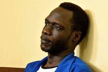 James-Gatdet-Dak,-a-former-spokesman-of-rebel-leader-Riek-Machar,-sits-inside-the-dock-in-the-High-Court-in-Juba,-South-Sudan-February-12,-2018.-Samir-Bol