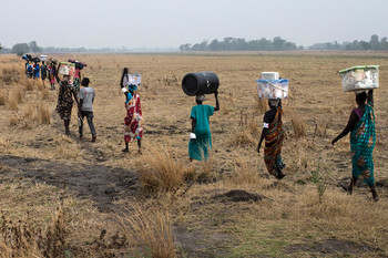 Women carry MSF equipment as the medical team moves from one location to the other to be flown out of the area after having finished their work at various MSF outdoor support clinics, close to Thaker, Leer County, South Sudan, March 23, 2017.