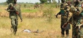 File photo: SPLA soldiers stand close to a dead body in the camp of Lalo following fighting, close to Malakal, October 16, 2016. REUTERS