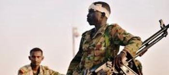 Sudanese soldiers look on as demonstrators attended a protest demanding Omar al-Bashir to step down outside the ministry headquarters in Khartoum on April 8. (Reuters)