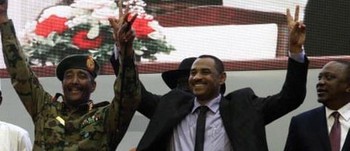 Ahmed Al-Rabie (second right), gives the victory gesture alongside Gen Abdel Fattah al-Burhan (C), the head of Sudan’s Military Council after the agreement was signed. Photograph: Ebrahim Hamid/AFP/Getty Images