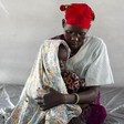 Photo: A woman holds her son, who is suffering from dehydration and is unable to walk, at an emergency medical facility supported by UNICEF in Kuach, South Sudan.(Credit: AP)