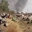 Photo: Malakal PoC residents take shelter in a UNMISS logistics area as fire engulfs their tents in the protection site (Credit: UNMISS)