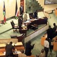 File photo: South Sudanese MPs stand during a parliamentary session in Juba on 31 August 2011 (AFP)
