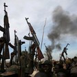 File photo: Rebel fighters hold up their rifles as they walk in front of a bushfire in a rebel-controlled territory in Upper Nile State in 2014. (REUTERS)