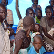 File photo: Internally displaced women and children sit in a tent in Ganyiel village in South Sudan. (AFP)