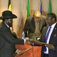 File photo: South Sudan's President Salva Kiir (front L) and South Sudan's rebel commander Riek Machar exchange documents after signing a cease-fire agreement during the Inter-Governmental Authority on Development (IGAD) Summit on the case of South Sudan in Ethiopia's capital Addis Ababa, Feb. 1, 2015.