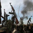 File photo: Rebel fighters hold up their rifles as they walk in front of a bushfire in a rebel-controlled territory in Upper Nile State, February 13, 2014. (REUTERS)