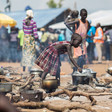 A young South Sudanese refugee cooks food at a camp in northern Uganda Photo: UNHCR/Will Swanson